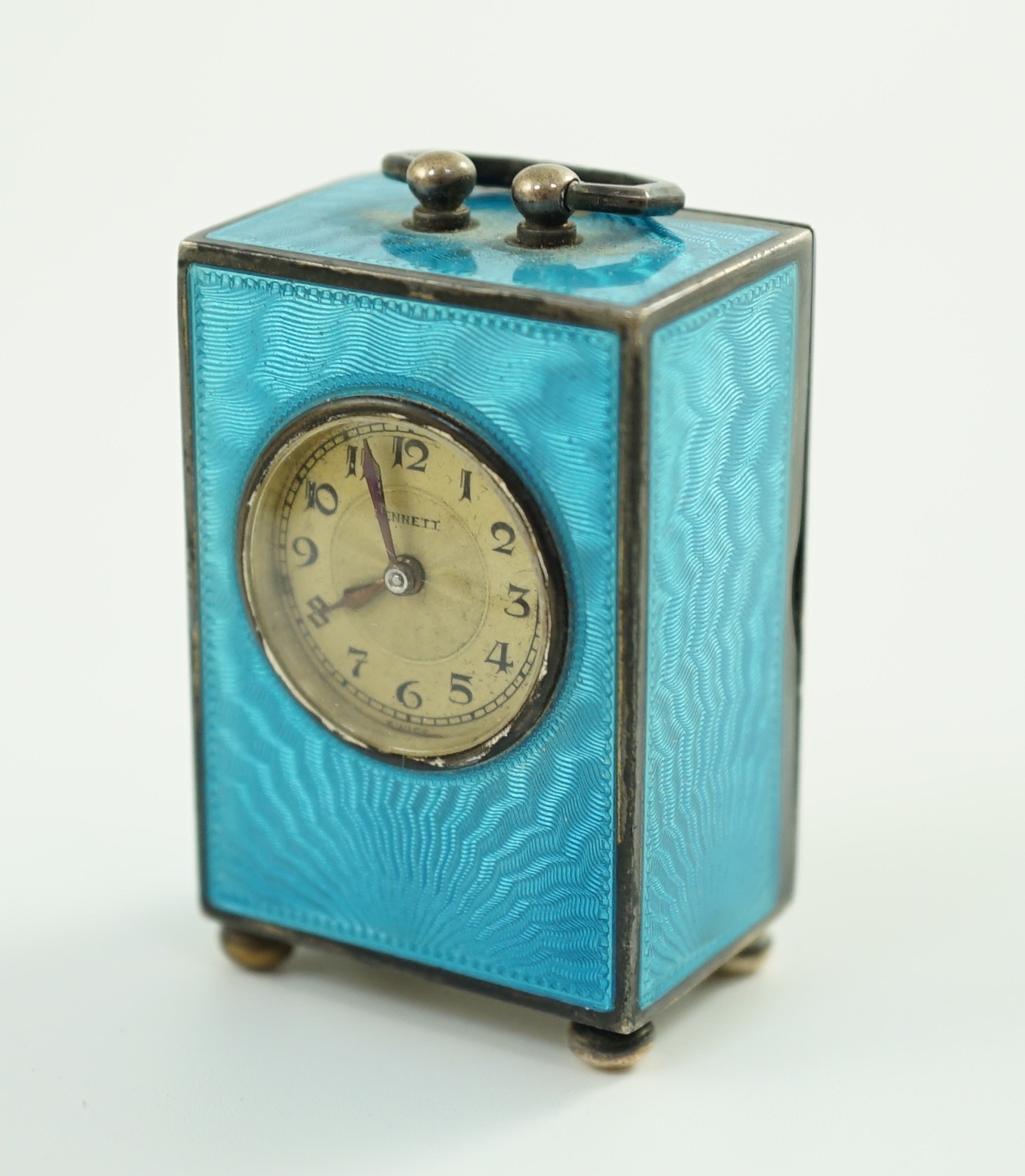A George V Swiss blue enamel and silver cased miniature carriage timepiece, import marks for Arthur George Rendell, London, 1924, 43mm, on bun feet, in gilt tooled leather carrying case